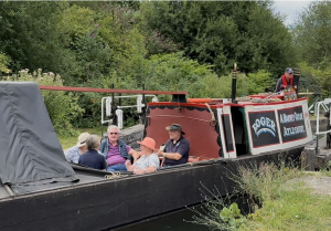 People sitting on a historic narrowboat